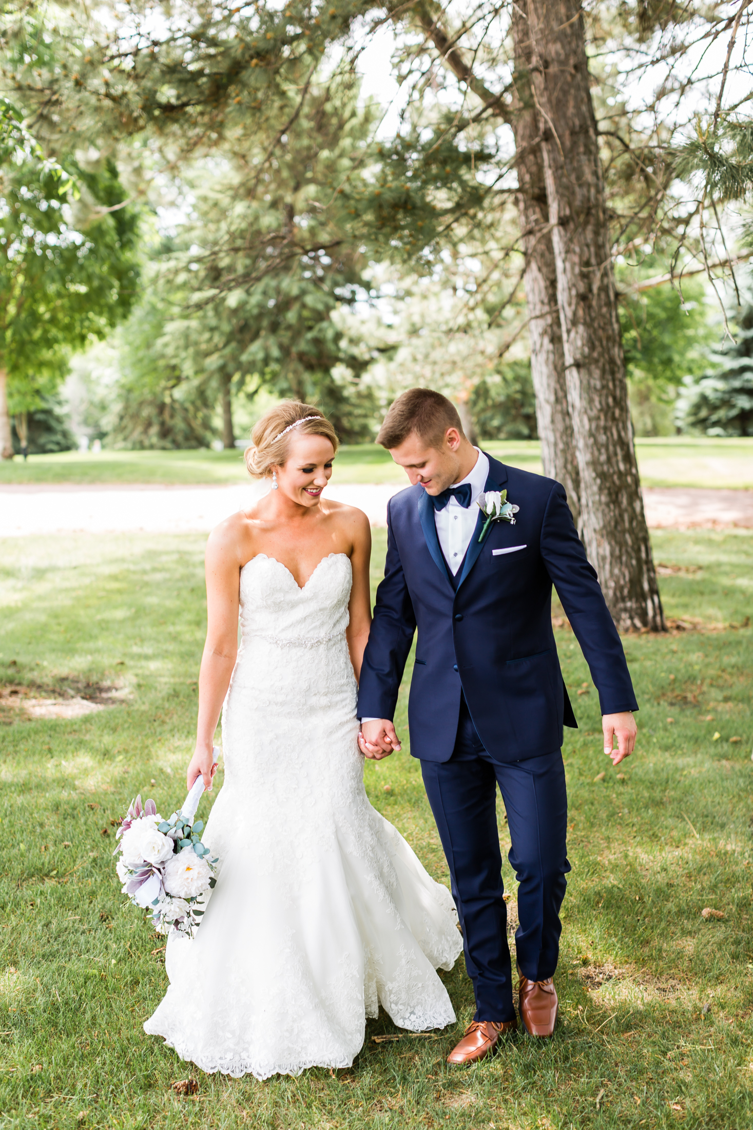 couple walking in woods on wedding day