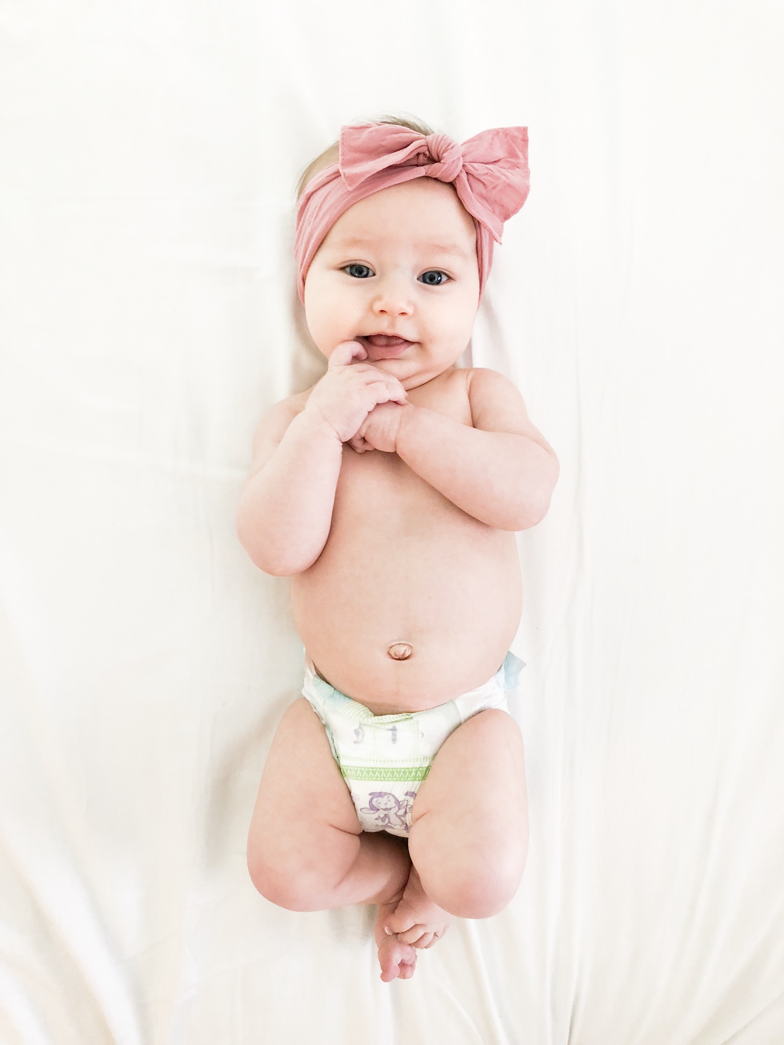 baby girl wearing pink bow