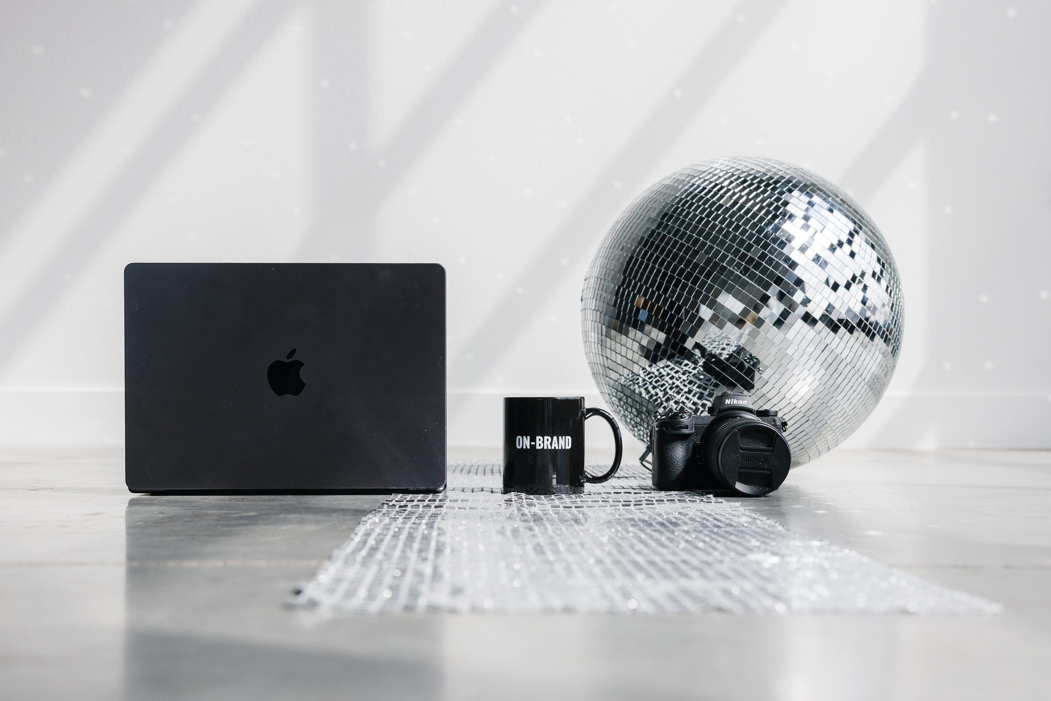 Computer, mug, camera, disco ball in White Space photography studio