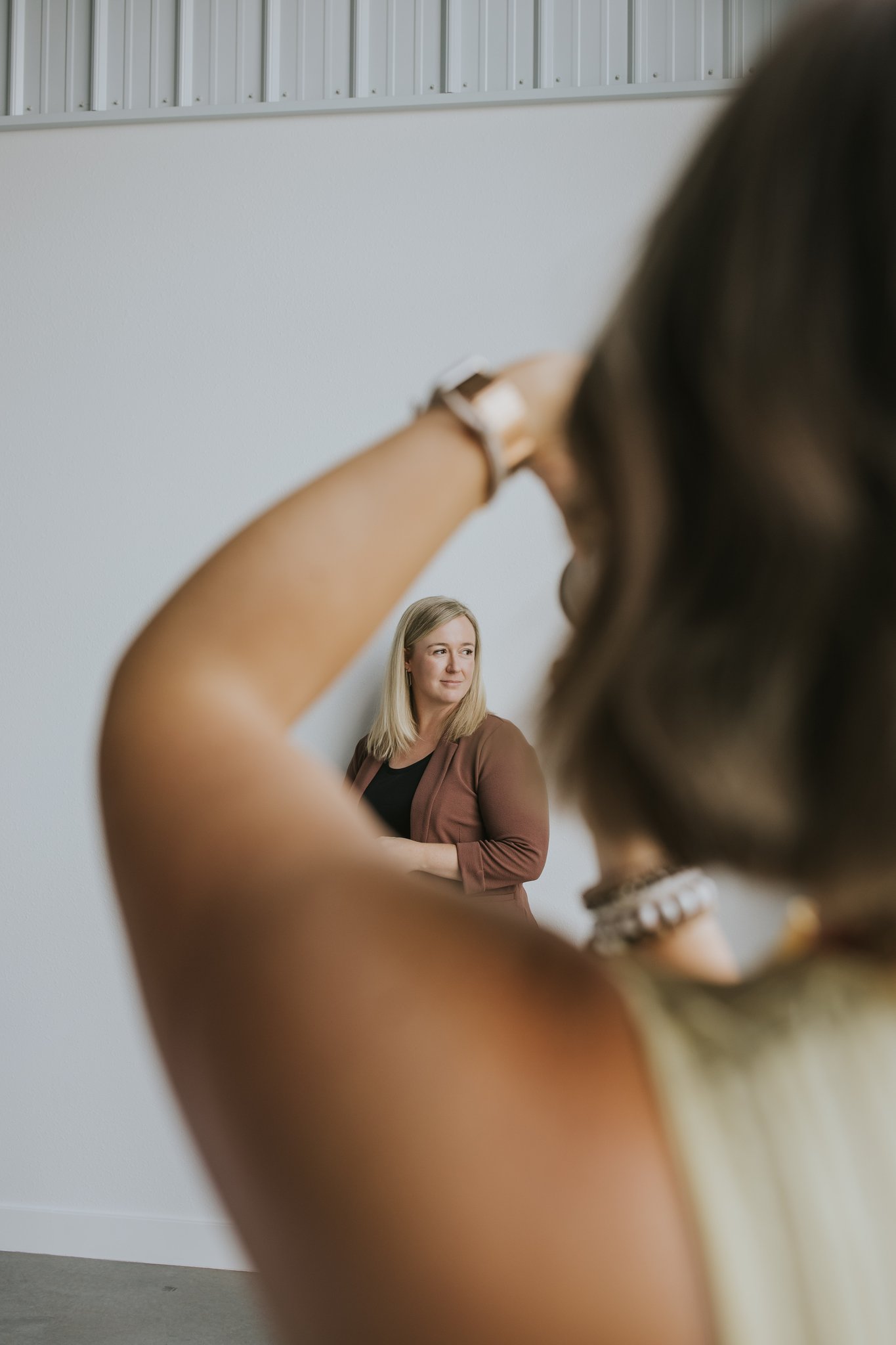 Photographer photographing a blonde woman for a headshot