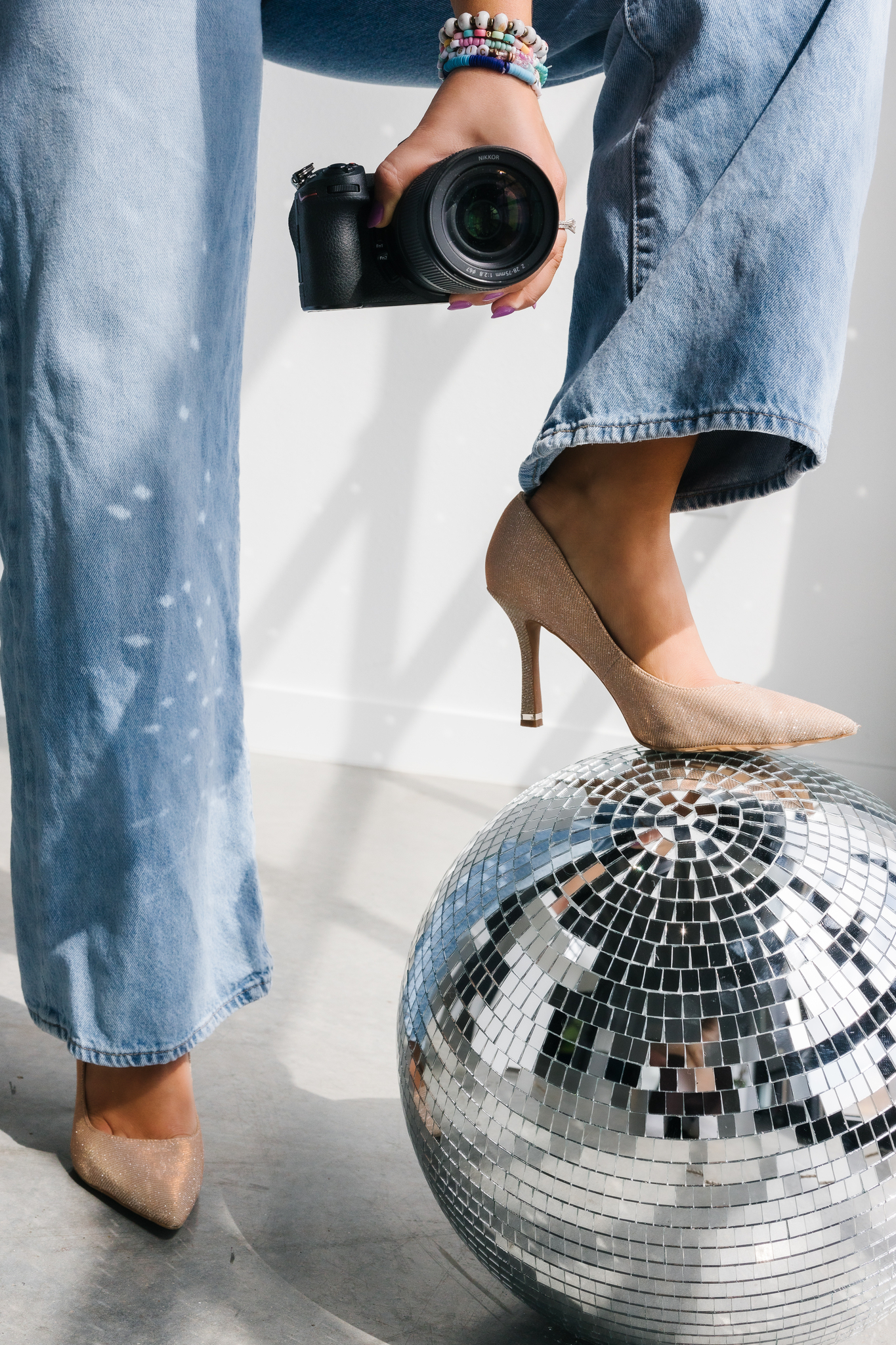 Maddie Peschong heels on disco ball for podcast episode photo cover