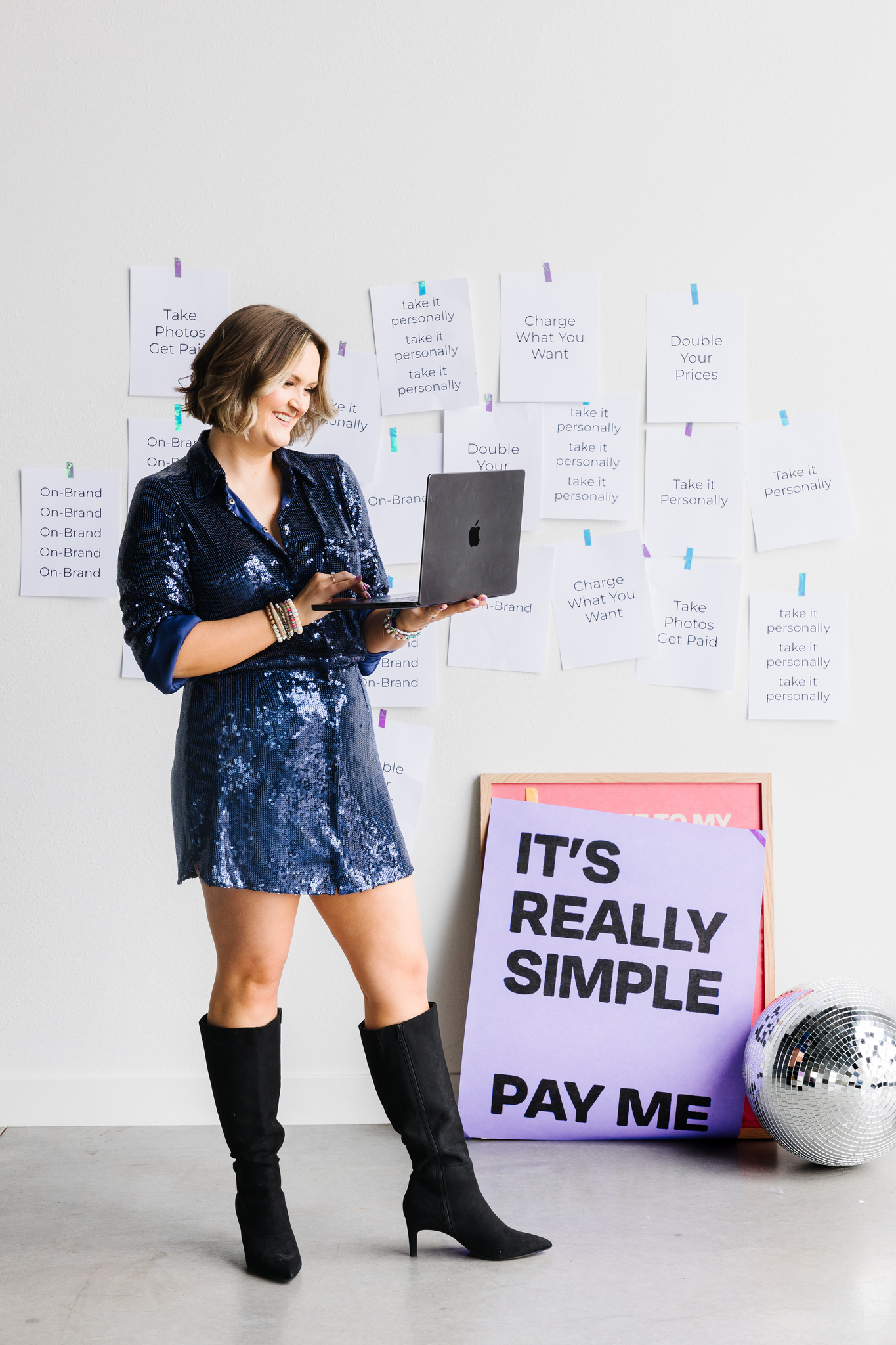 Brand photographer coaching how to make more clients on Instagram holding computer Zoom call