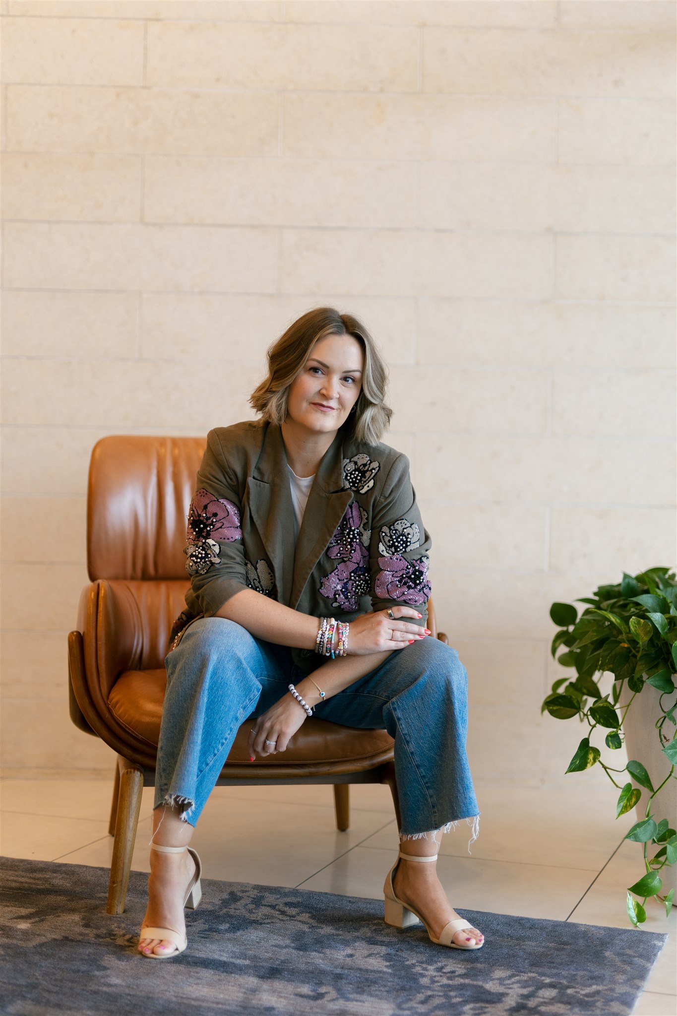 Maddie sitting in chair with blazer on discussing thought leadership on social media