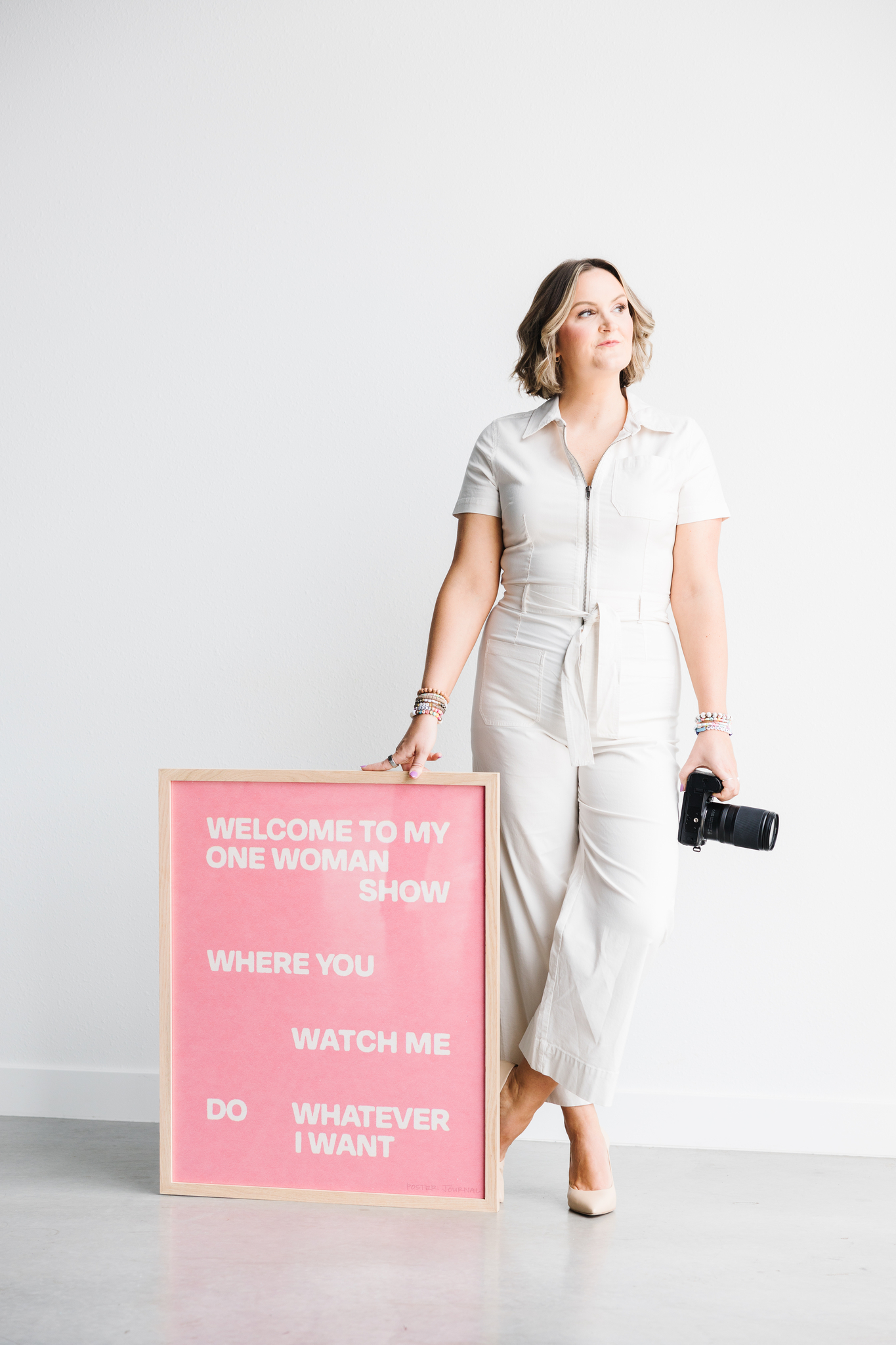 Maddie Peschong brand photographer by bold sign with camera