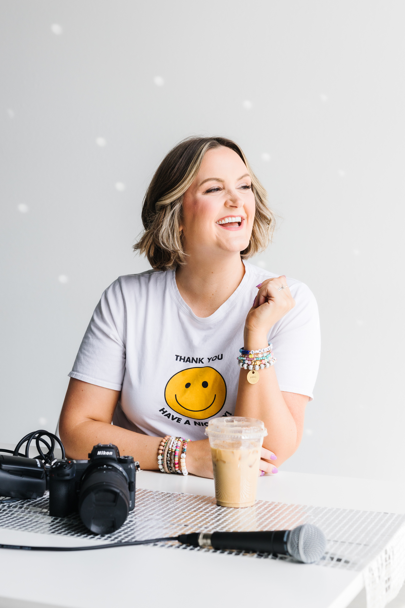 Maddie sitting at desk to educate on lessons of being a brand photographer